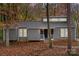 Charming gray home with clerestory windows and a welcoming front porch nestled in a wooded setting at 958 Sherwood Cir, Lancaster, SC 29720