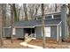 Charming home featuring a gray exterior, complemented by white trim and a cozy front porch with wooden railing at 958 Sherwood Cir, Lancaster, SC 29720