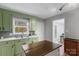 Bright kitchen with green cabinets, stainless steel sink, and natural light, offering a functional workspace at 958 Sherwood Cir, Lancaster, SC 29720