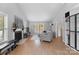 Open living space with a fireplace, wood floors, neutral walls, and large windows for plenty of light at 958 Sherwood Cir, Lancaster, SC 29720