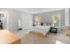 Bright main bedroom features two windows, a king bed, neutral colors, and closet at 958 Sherwood Cir, Lancaster, SC 29720