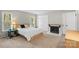 Spacious main bedroom features a fireplace, two windows, a king bed, and neutral colors at 958 Sherwood Cir, Lancaster, SC 29720