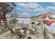 Lakefront deck with wooden chairs and table at 110 Fern Haven Ln, Mooresville, NC 28117