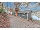 Gray lakefront cottage with blue door, metal roof, and gravel driveway at 110 Fern Haven Ln, Mooresville, NC 28117