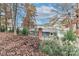 Gray lakefront house nestled among autumn trees at 110 Fern Haven Ln, Mooresville, NC 28117
