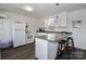 White kitchen with L-shaped counter, stainless steel sink, and breakfast bar at 110 Fern Haven Ln, Mooresville, NC 28117