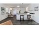 White kitchen with L-shaped counter, stainless steel sink, and breakfast bar at 110 Fern Haven Ln, Mooresville, NC 28117