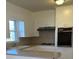 Bright kitchen with white cabinets, built-in oven, and neutral countertops at 1243 Wendover St, Albemarle, NC 28001