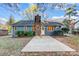 A single-Gathering home backyard featuring a brick chimney and small bushes at 13446 Idlefield Ln, Matthews, NC 28105