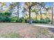 Large grassy backyard with a shed and mature trees perfect for outdoor activities and relaxation at 13446 Idlefield Ln, Matthews, NC 28105