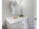 Well-lit bathroom features white vanity with countertop space and storage at 13446 Idlefield Ln, Matthews, NC 28105