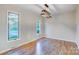Bright dining room with wood floors, modern light fixture, and large windows at 13446 Idlefield Ln, Matthews, NC 28105