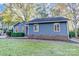 Side view of a charming blue house with manicured landscaping and brick foundation at 13446 Idlefield Ln, Matthews, NC 28105