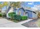 Charming blue home with attached garage, manicured landscaping, and concrete walkway at 13446 Idlefield Ln, Matthews, NC 28105