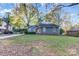 Charming blue home with lush lawn, driveway, and mature trees at 13446 Idlefield Ln, Matthews, NC 28105