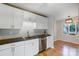 Kitchen featuring white cabinets, stainless steel appliances, and open view to dining room at 13446 Idlefield Ln, Matthews, NC 28105