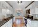 Open kitchen with white cabinets, stainless steel appliances, and a view into the dining area at 13446 Idlefield Ln, Matthews, NC 28105