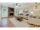 Inviting living room with brick fireplace, ceiling fan, and neutral-toned furniture at 13446 Idlefield Ln, Matthews, NC 28105