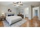 Bedroom suite showcasing modern decor, wood flooring, and attached bathroom at 13446 Idlefield Ln, Matthews, NC 28105