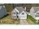 An eye-level view of a charming two-story home with mature landscaping, a driveway, and a two car garage at 3015 Hendricks Chapel Ln, Charlotte, NC 28216