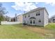 View of spacious, fenced backyard with patio, grill, and lawn, perfect for outdoor activities and entertaining at 3015 Hendricks Chapel Ln, Charlotte, NC 28216