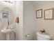 Powder room with pedestal sink, round mirror, and charming decorative wall art at 3015 Hendricks Chapel Ln, Charlotte, NC 28216