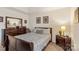 Comfortable bedroom featuring a full sized bed, dresser with mirror, and neutral color scheme at 3015 Hendricks Chapel Ln, Charlotte, NC 28216