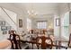 Formal dining room features elegant chandelier, and seamlessly transitions to the staircase and living room at 3015 Hendricks Chapel Ln, Charlotte, NC 28216