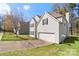 Charming two-story home featuring a well-maintained lawn, attached garage, and classic architectural details at 3015 Hendricks Chapel Ln, Charlotte, NC 28216