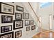 Bright foyer featuring hardwood floors, a staircase adorned with framed photos, and a welcoming front door at 3015 Hendricks Chapel Ln, Charlotte, NC 28216