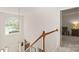 Upstairs hallway with natural light, showcasing the architectural details of the home at 3015 Hendricks Chapel Ln, Charlotte, NC 28216