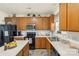 Kitchen featuring oak cabinetry, modern appliances, and ample counter space for cooking at 3015 Hendricks Chapel Ln, Charlotte, NC 28216