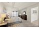 Bright main bedroom showcasing natural light, tray ceiling, and ample closet space at 3015 Hendricks Chapel Ln, Charlotte, NC 28216