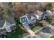 Beautiful aerial view of a light blue house with a landscaped front yard and a porch at 428 Vintage Hill Ln, Huntersville, NC 28078