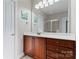 Bathroom featuring a cherry wood vanity, white countertops, and a glass shower enclosure at 428 Vintage Hill Ln, Huntersville, NC 28078