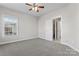 Bedroom with a ceiling fan, carpet, and a glimpse of an adjacent bathroom at 428 Vintage Hill Ln, Huntersville, NC 28078