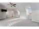 Bright bedroom featuring a ceiling fan, plush carpeting, and a well-lit interior at 428 Vintage Hill Ln, Huntersville, NC 28078
