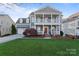 Charming two-story home with inviting double porch and well-manicured lawn at 428 Vintage Hill Ln, Huntersville, NC 28078
