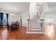 Elegant foyer featuring hardwood floors, staircase with wooden banister, and adjacent dining area at 428 Vintage Hill Ln, Huntersville, NC 28078