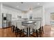 Bright, open kitchen featuring a large center island with seating, stainless steel appliances, and hardwood floors at 428 Vintage Hill Ln, Huntersville, NC 28078