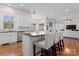 Well-lit kitchen with stainless steel appliances, island with bar stools, and adjacent dining area at 428 Vintage Hill Ln, Huntersville, NC 28078