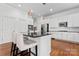 Modern kitchen with stainless steel appliances, center island with barstools, and hardwood floors at 428 Vintage Hill Ln, Huntersville, NC 28078