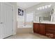 Bright main bathroom featuring a soaking tub, tile floors, and dual sink vanity at 428 Vintage Hill Ln, Huntersville, NC 28078