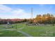 Community playground with a covered gazebo, benches, and walking paths at 428 Vintage Hill Ln, Huntersville, NC 28078