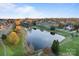Aerial view of a pond with a walking path, landscaping, and neighborhood homes in the background at 428 Vintage Hill Ln, Huntersville, NC 28078