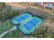 Aerial view of two well-maintained tennis courts surrounded by lush greenery at 428 Vintage Hill Ln, Huntersville, NC 28078