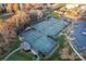 Aerial view of a tennis court complex surrounded by trees, sidewalks, and parking at 428 Vintage Hill Ln, Huntersville, NC 28078