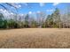 Expansive backyard featuring trees surrounding the open space at 6610 Rolling Ridge Dr, Waxhaw, NC 28173
