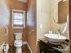 Cozy powder room with stylish sink, toilet, and unique wallpaper at 6610 Rolling Ridge Dr, Waxhaw, NC 28173
