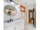 Stylish bathroom featuring a modern vanity with marble countertop and a round mirror at 6610 Rolling Ridge Dr, Waxhaw, NC 28173
